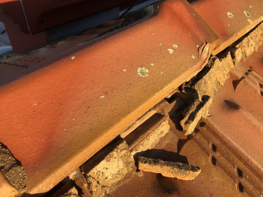 Broken and damaged roof ridge tile pointing